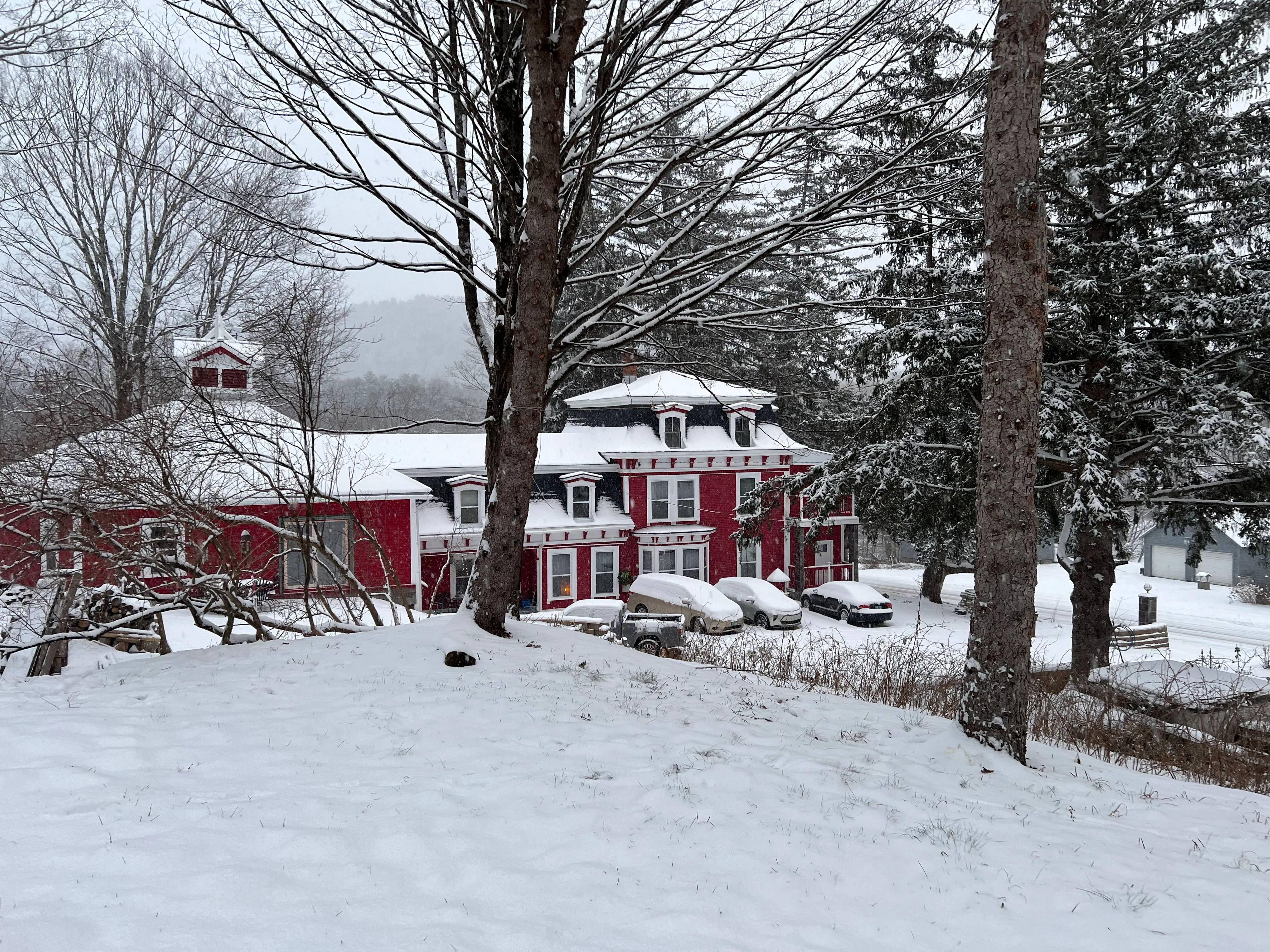 The 1872 house on its rise above the valley, under fresh snow