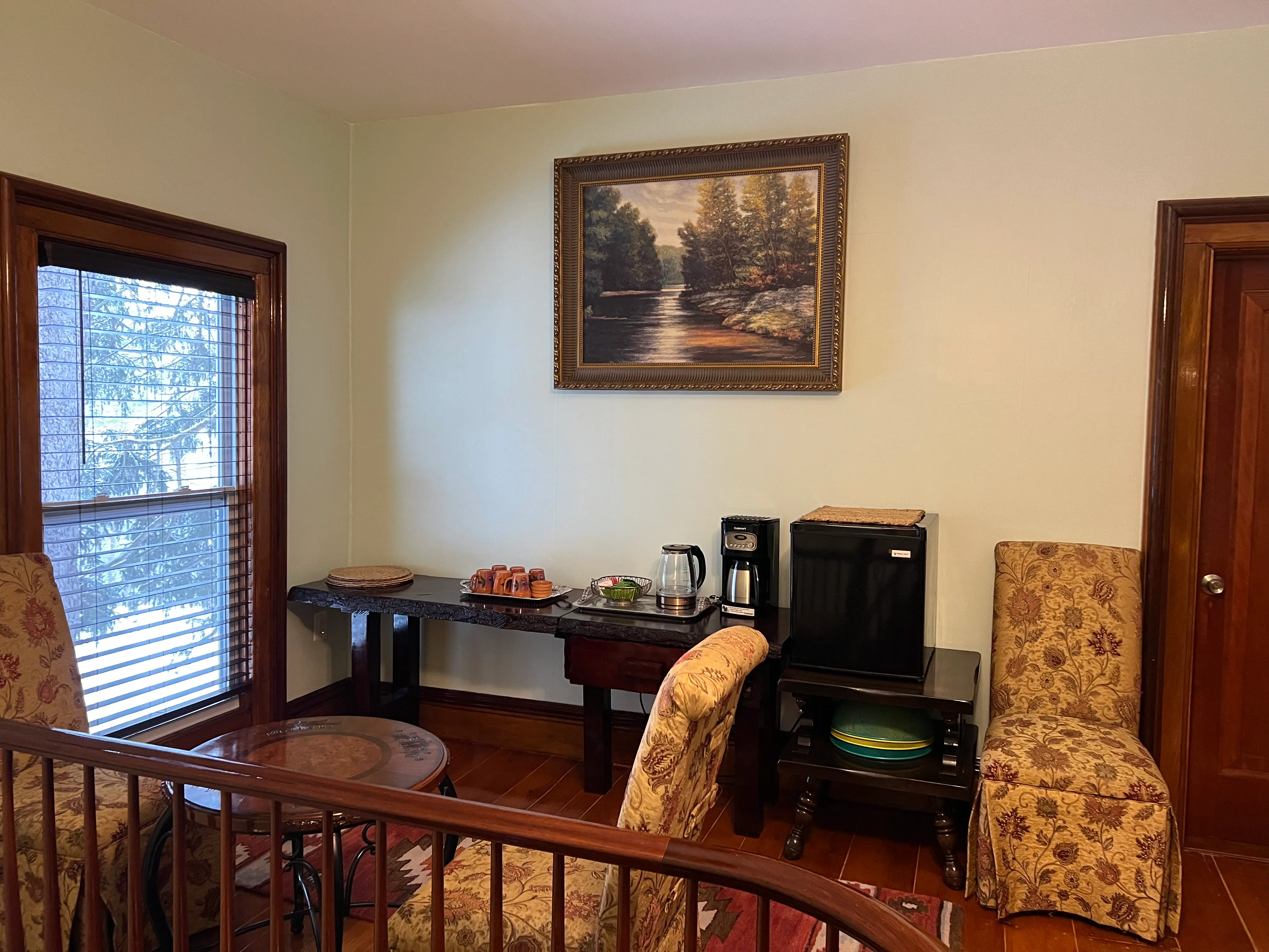 The breakfast room, with the coffee kept on under the river painting