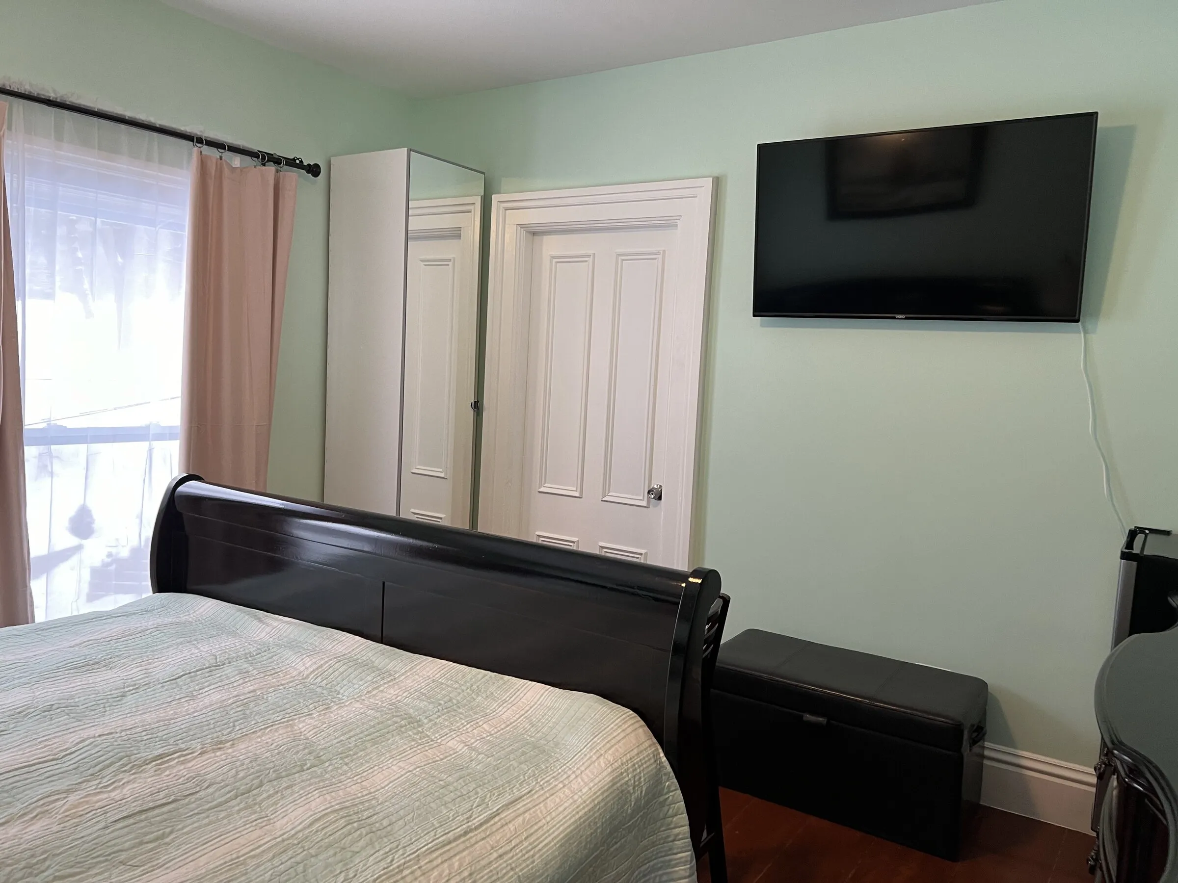 The bed, wardrobe, and television