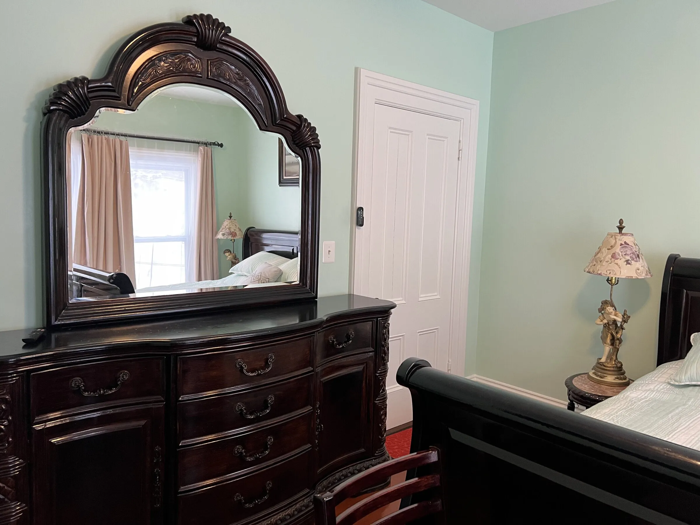 The carved dresser and mirror