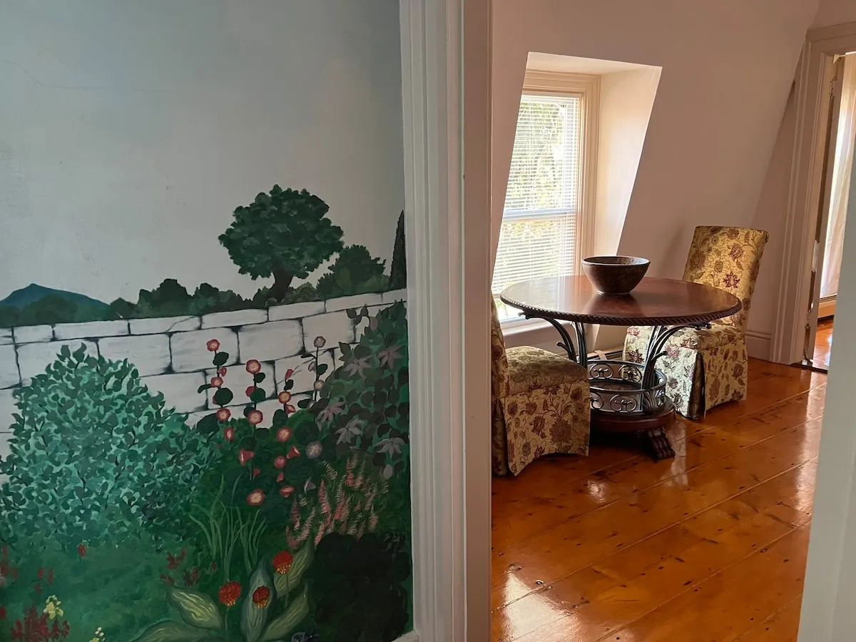 The hand-painted mural along the sitting-room wall