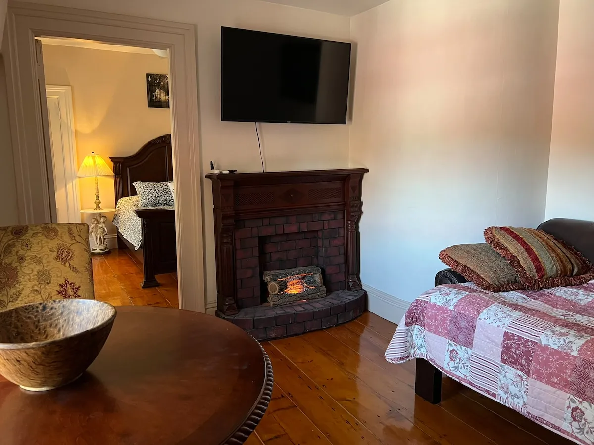 The fireplace, and the bedroom through the doorway