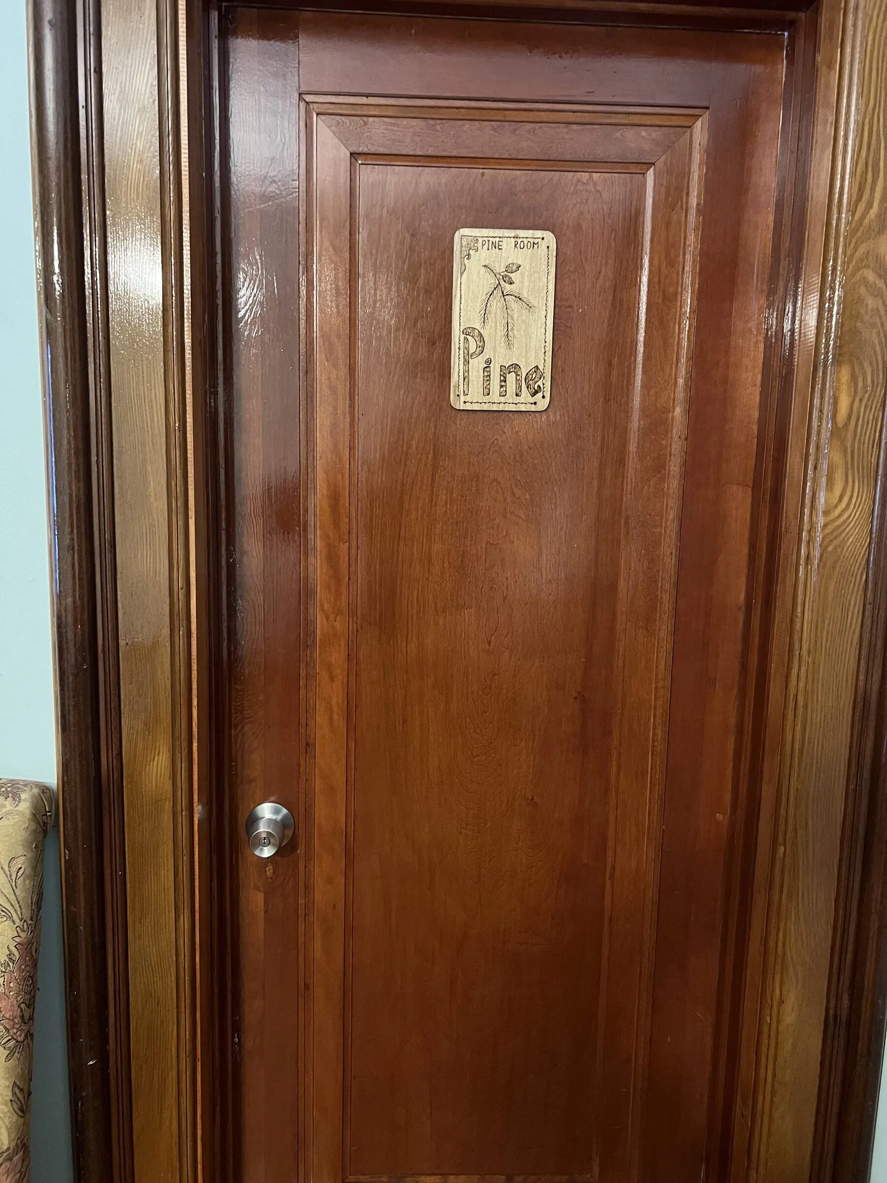 The carved nameplate on the door